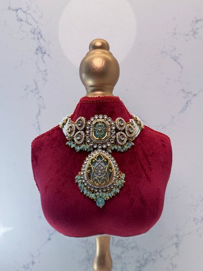 Decorative necklace on a red velvet mannequin bust against a marble background